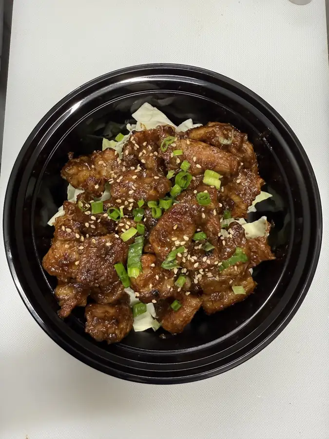 A beef bulgogi bowl with vegetables over rice
